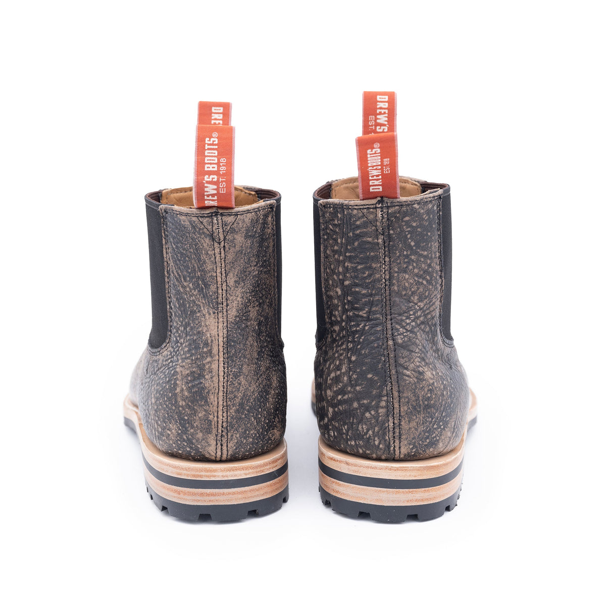Pair of brown leather boots with visible brand name on a white background